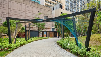 The installation forms a series of colourful arches which visitors can walk through. When sunlight penetrates through the patterned canopy, the shadow will tint and cast different patterns onto the visitors and the pathway.